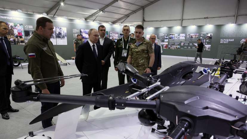 Russian President Vladimir Putin tours a military exhibition in Moscow