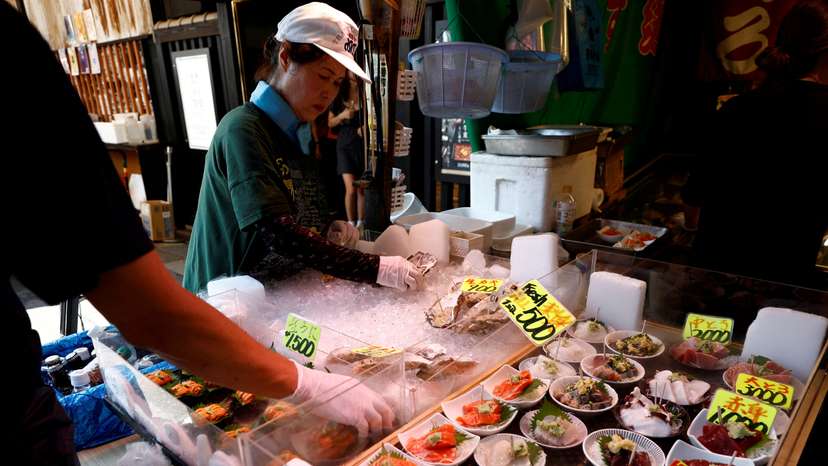 Vendors prepare seafood for sale at Tsukiji Outer Market in Tokyo
