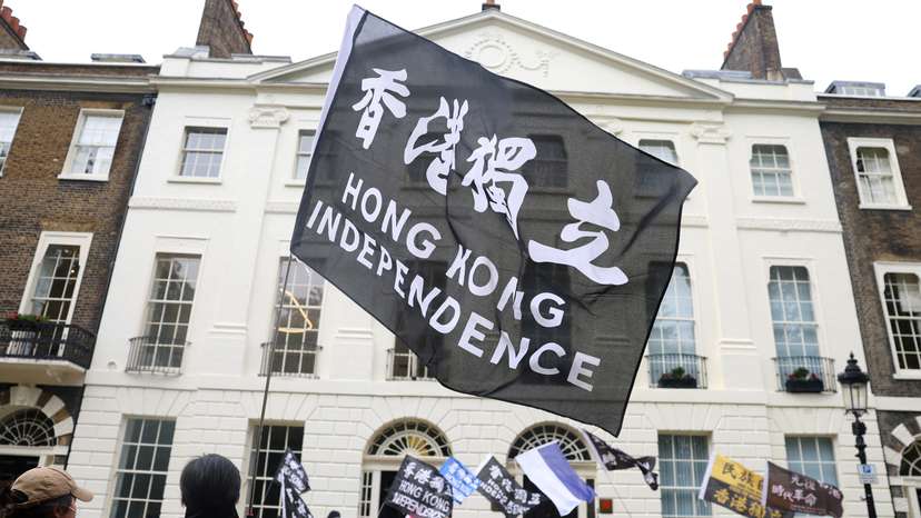 FILE PHOTO: People demonstrate outside the Hong Kong Economic and Trade Office, after three men were charged with assisting Hong Kong's foreign intelligence service in Britain, in London