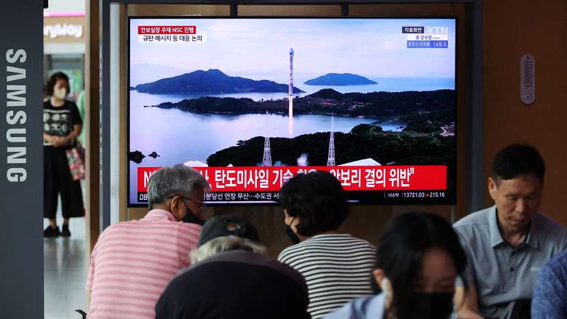 TV broadcasting a news report on North Korea firing a space rocket, at a railway station in Seoul