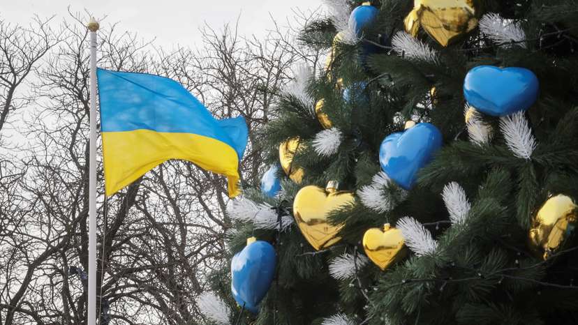 A view shows a Christmas tree near a Ukrainian national flag in Kyiv