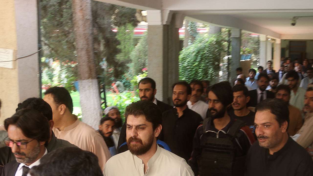 Policemen escort tribal chief Sher Baz Satakzai, in Quetta