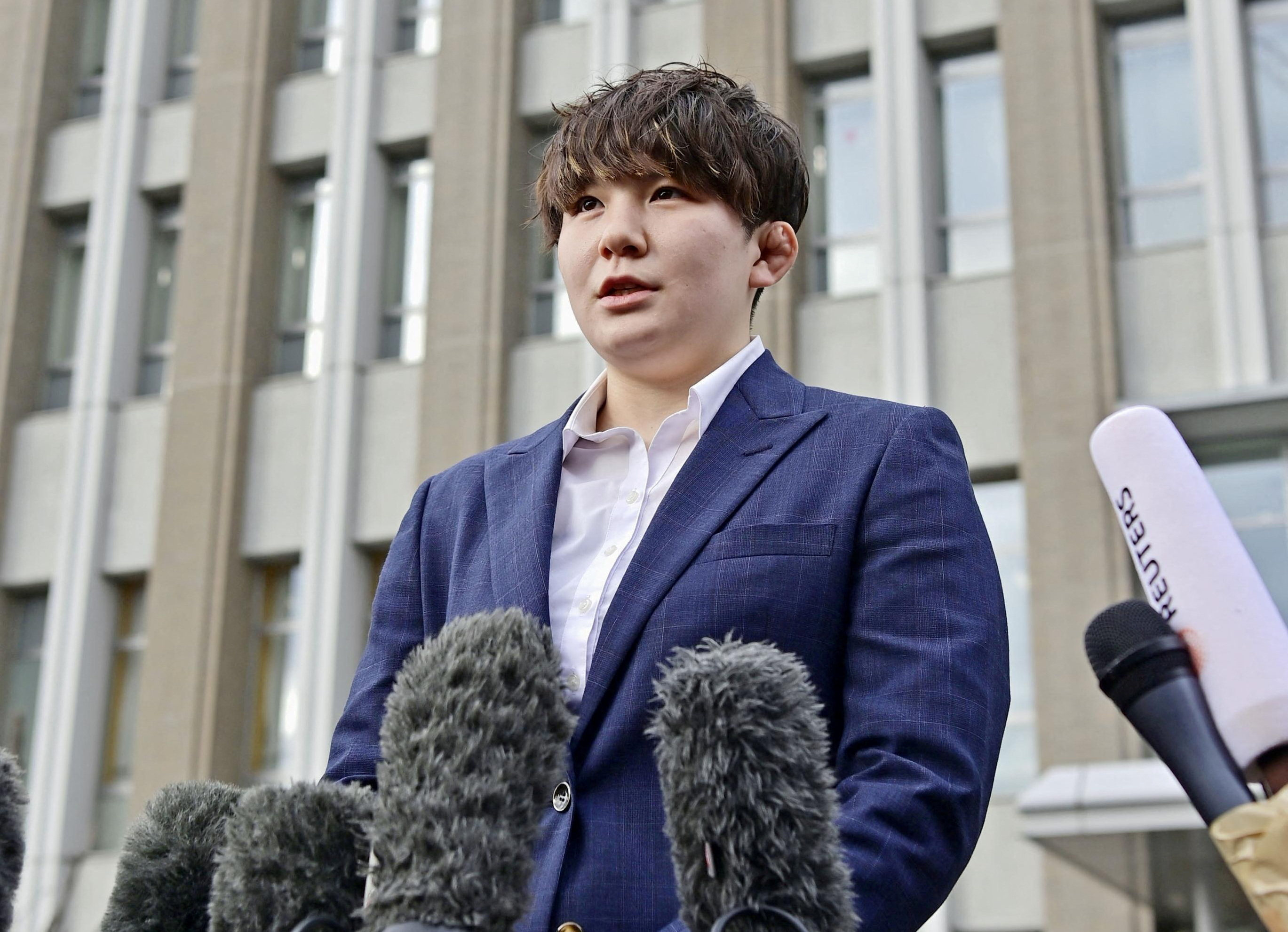 Rina Gonoi, a former member of Japan Self-Defense Forces speaks to the media at the Fukushima District Court in Fukushima