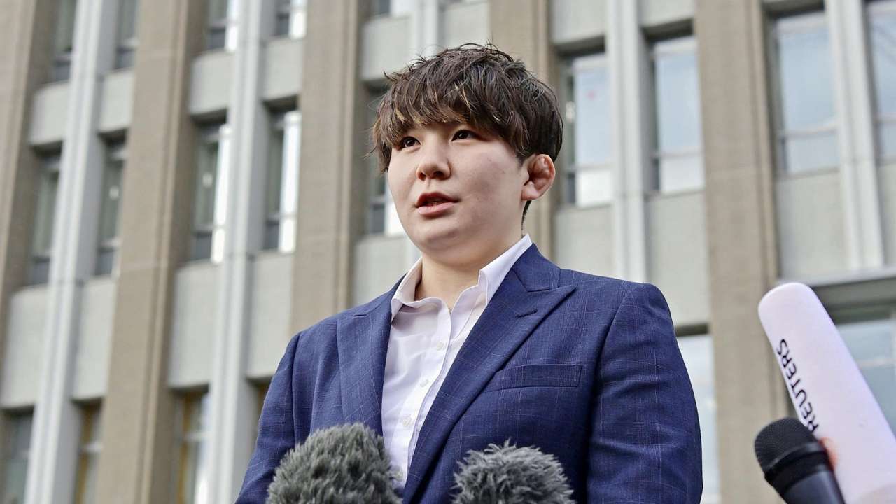 Rina Gonoi, a former member of Japan Self-Defense Forces speaks to the media at the Fukushima District Court in Fukushima