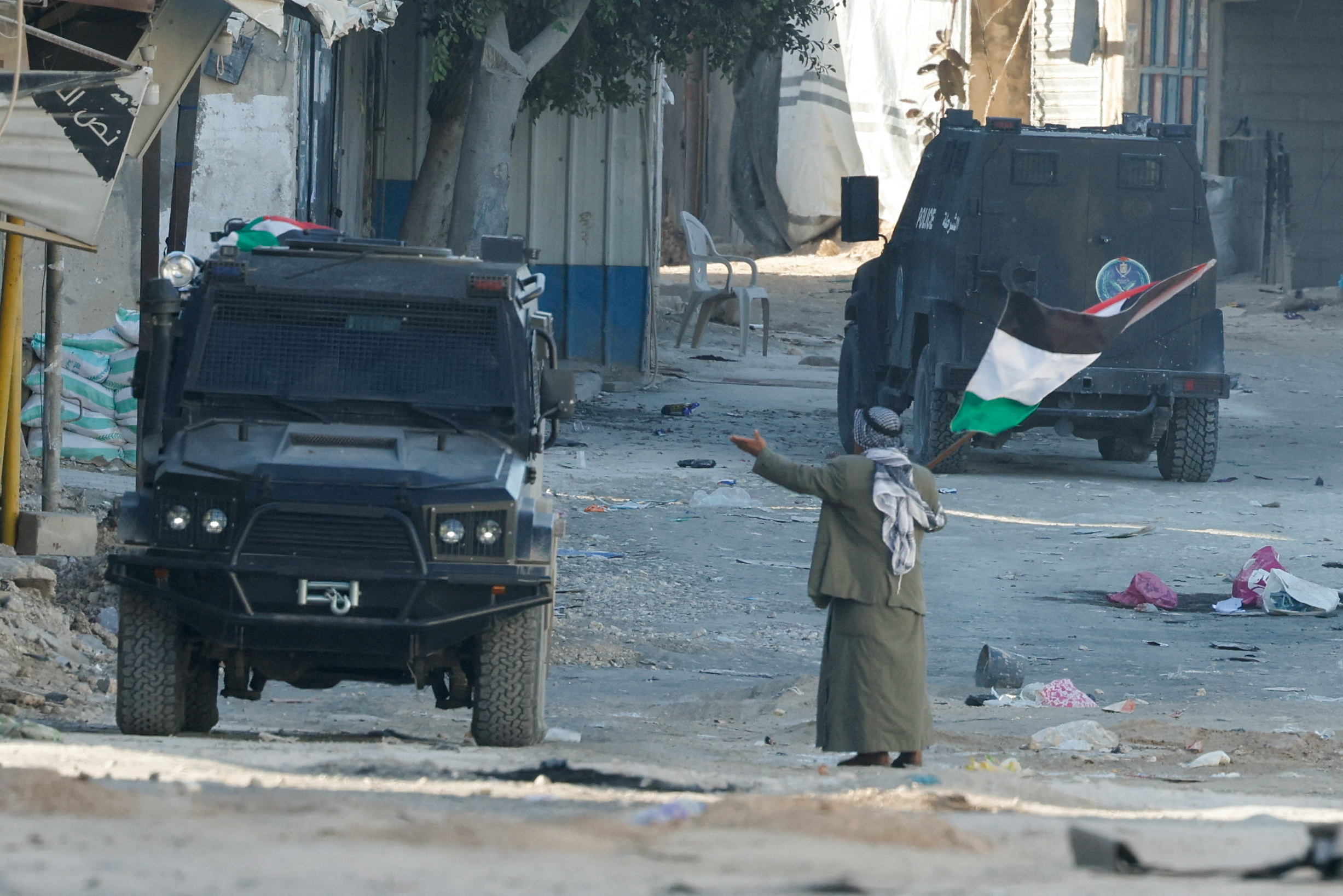 Palestinian security forces clash with militants at the camp, in Jenin
