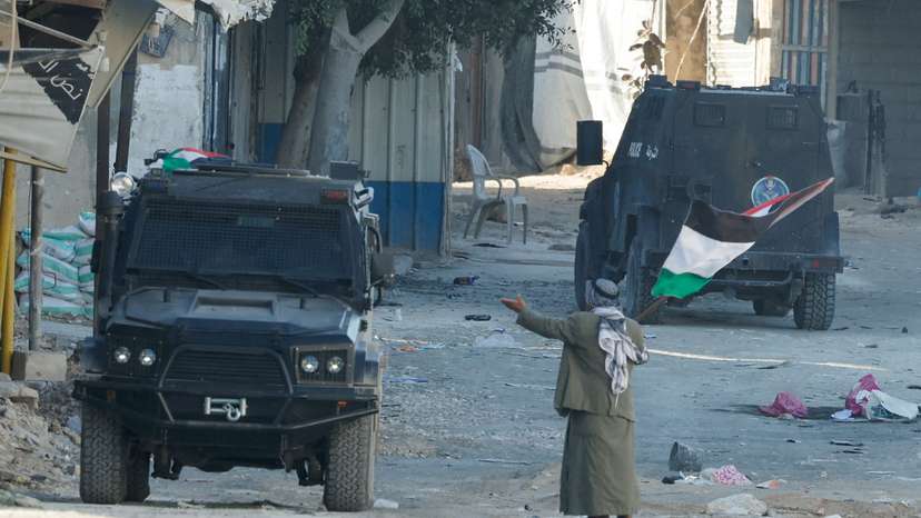 Palestinian security forces clash with militants at the camp, in Jenin