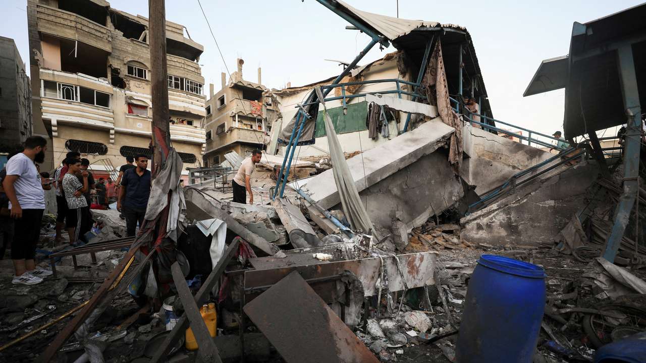 Palestinians gather at a UN school sheltering displaced people, following an Israeli strike, amid Israel-Hamas conflict, in Gaza City