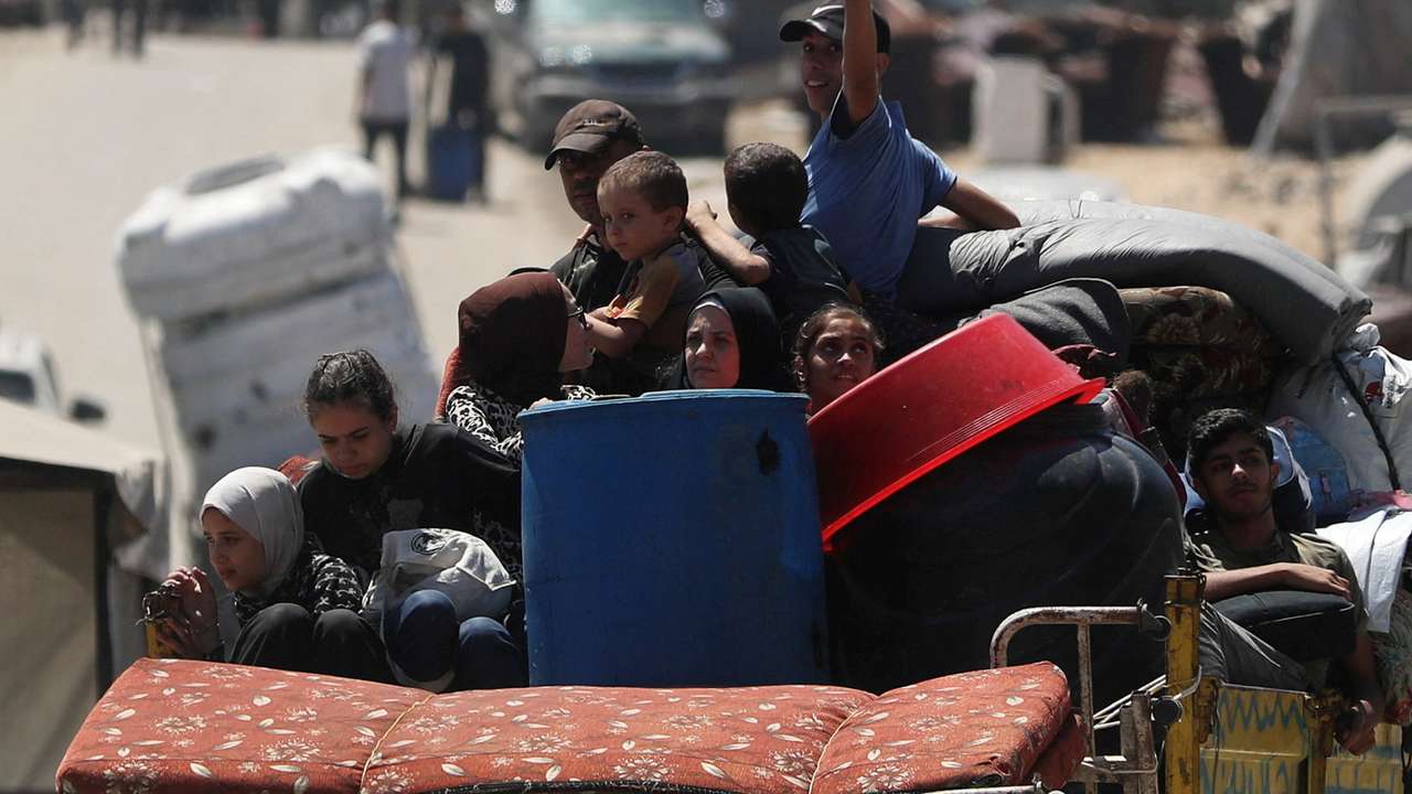 Displaced Palestinians make their way as they flee amid an Israeli military operation, in Gaza City
