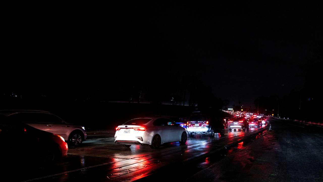 Cars drive on the 101 highway during an ongoing rain storm in Los Angeles