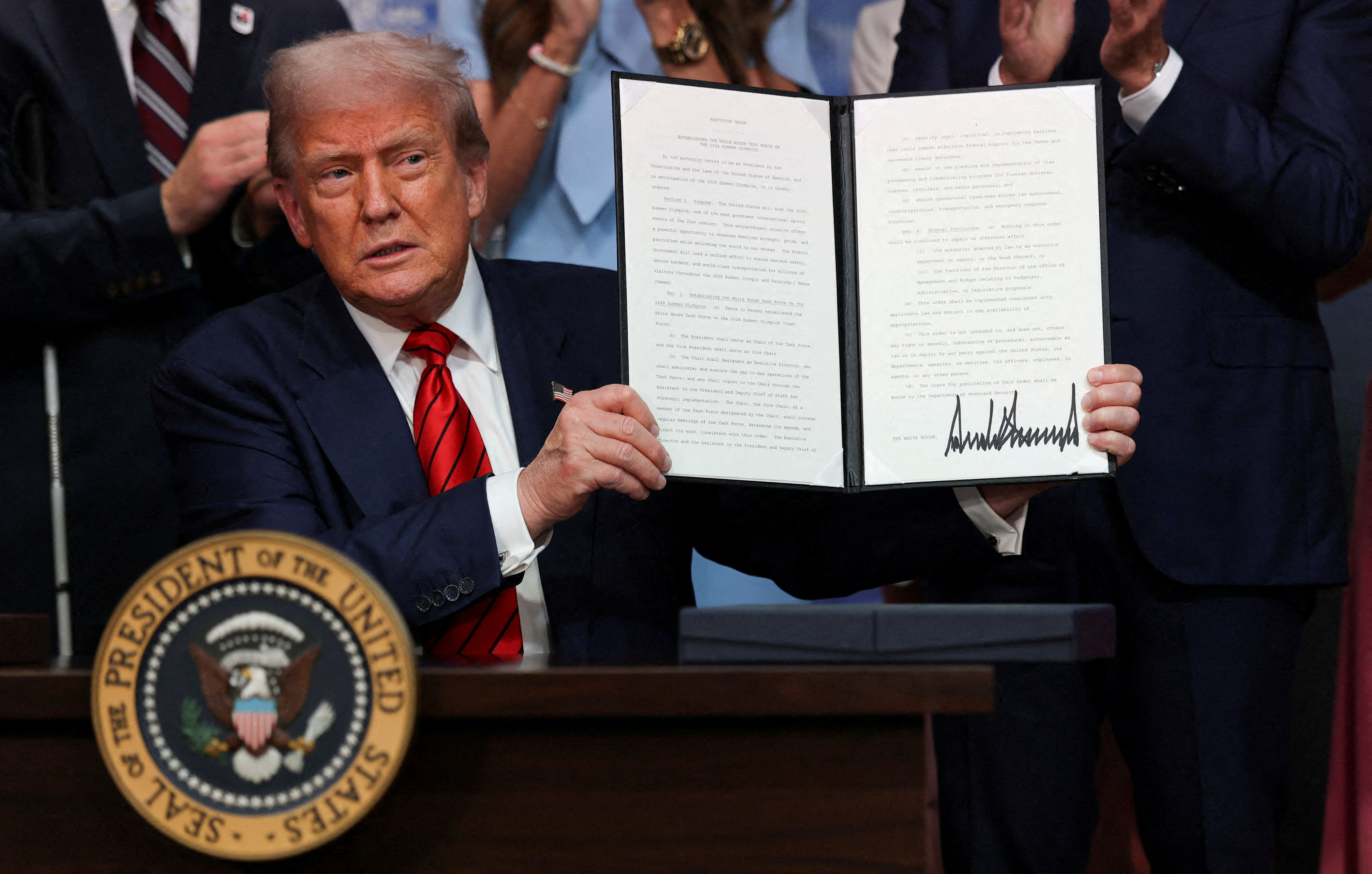 FILE PHOTO: U.S. President Donald Trump signs an executive order, in Washington
