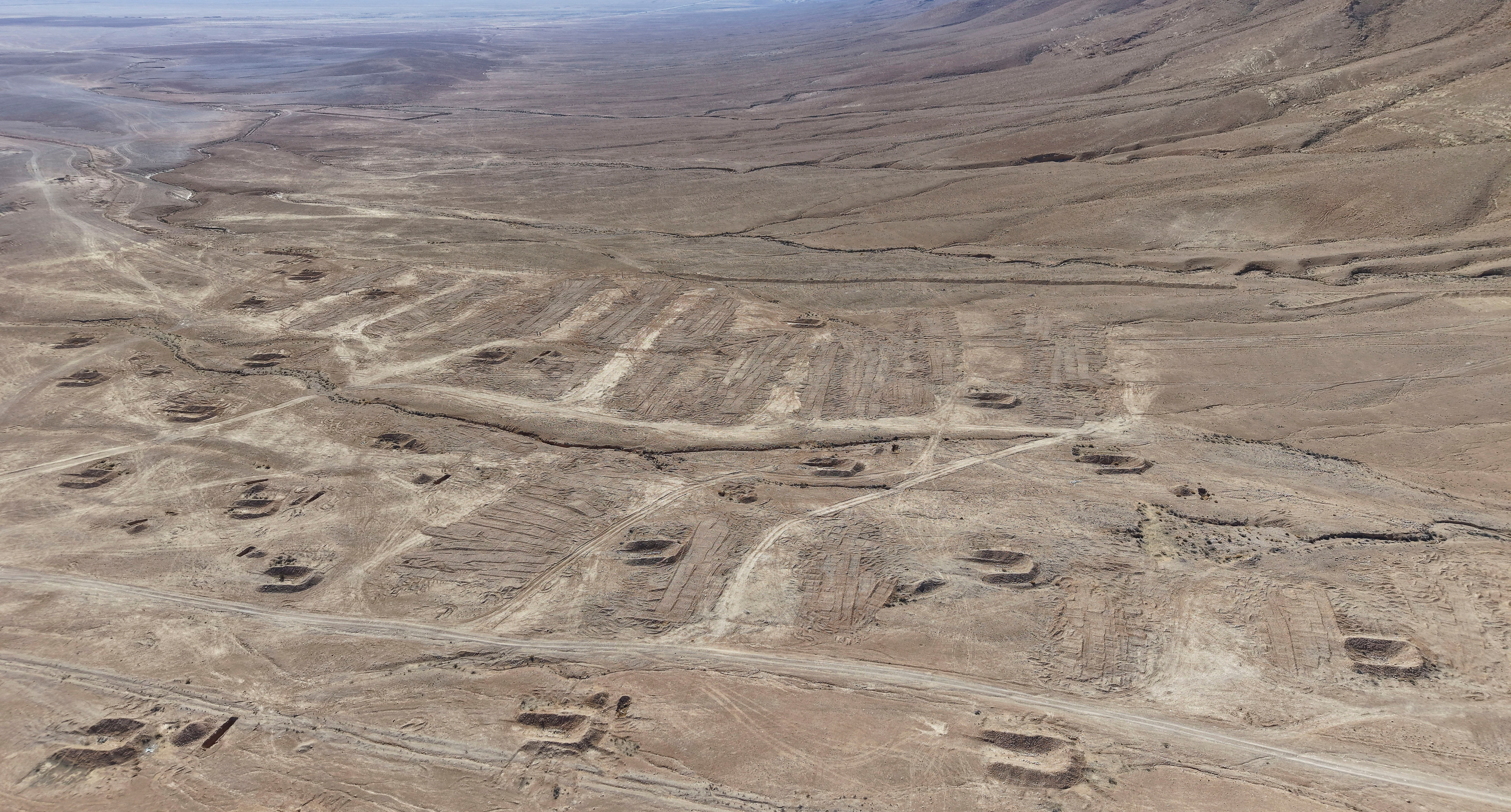 A drone view of the mass grave site in the desert near the eastern Syrian town of Dhumair