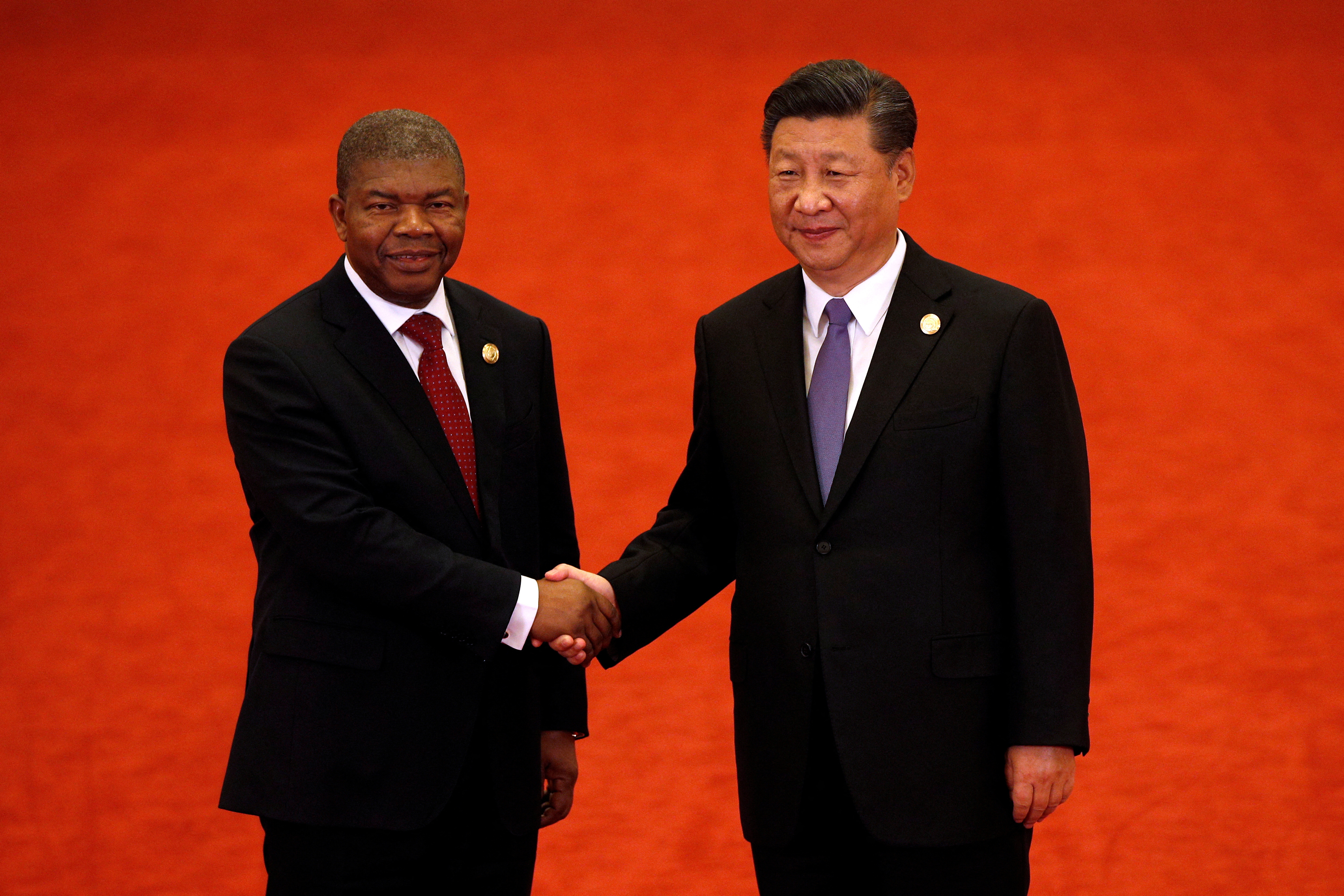 FILE PHOTO: Angola's President Joao Lourenco, left, shakes hands with Chinese President Xi Jinping during the Forum on China-Africa Cooperation held at the Great Hall of the People in Beijing