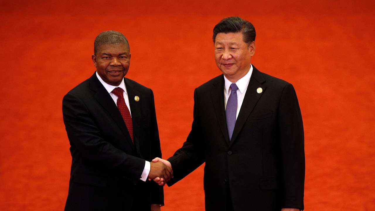 FILE PHOTO: Angola's President Joao Lourenco, left, shakes hands with Chinese President Xi Jinping during the Forum on China-Africa Cooperation held at the Great Hall of the People in Beijing