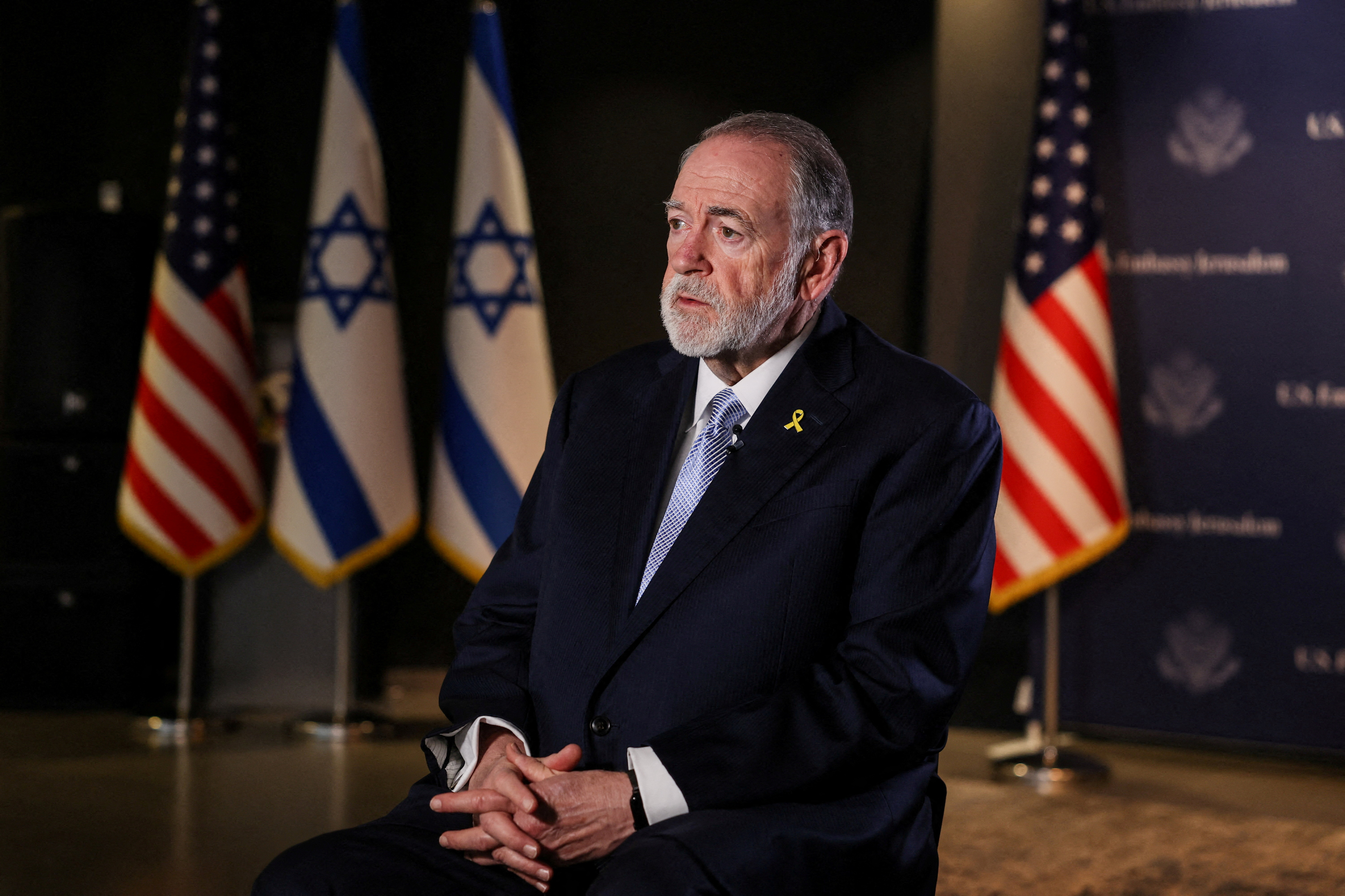 FILE PHOTO: U.S. Ambassador to Israel Mike Huckabee looks on during an interview with Reuters in Jerusalem