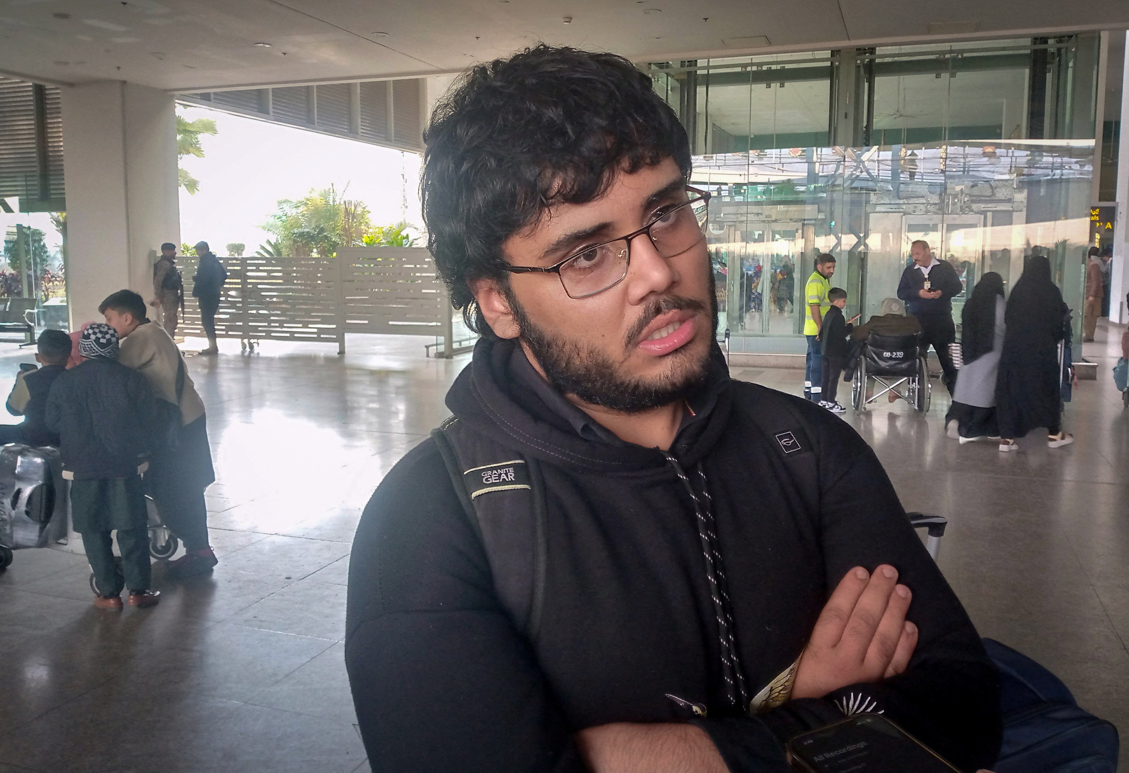 A Pakistani medical student Shahanshah Abbas waits at the airport after arriving from Tehran on a commercial flight amid the ongoing nationwide protests in Iran, in Islamabad