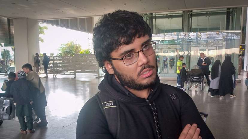 A Pakistani medical student Shahanshah Abbas waits at the airport after arriving from Tehran on a commercial flight amid the ongoing nationwide protests in Iran, in Islamabad