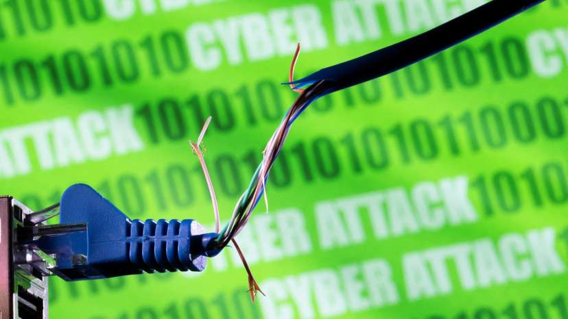 FILE PHOTO: Illustration shows broken Ethernet cable, binary code and words 'cyber attack'