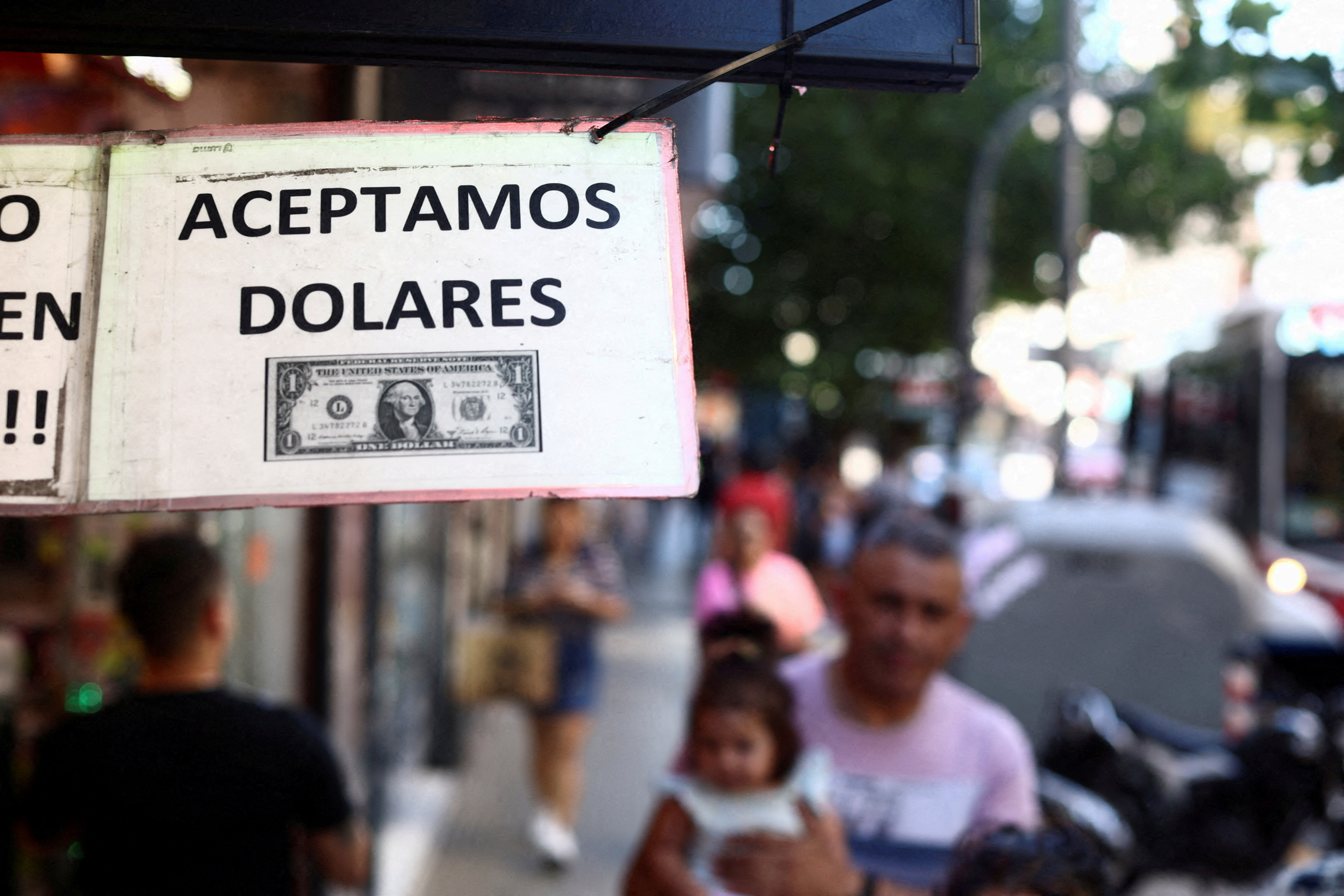 FILE PHOTO: A sign outside a store reads in Spanish "We accept Dollars" in Buenos Aires