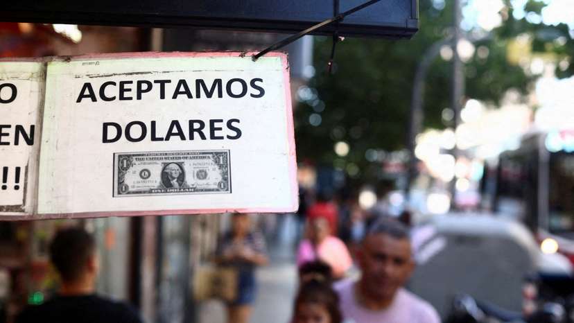 FILE PHOTO: A sign outside a store reads in Spanish "We accept Dollars" in Buenos Aires