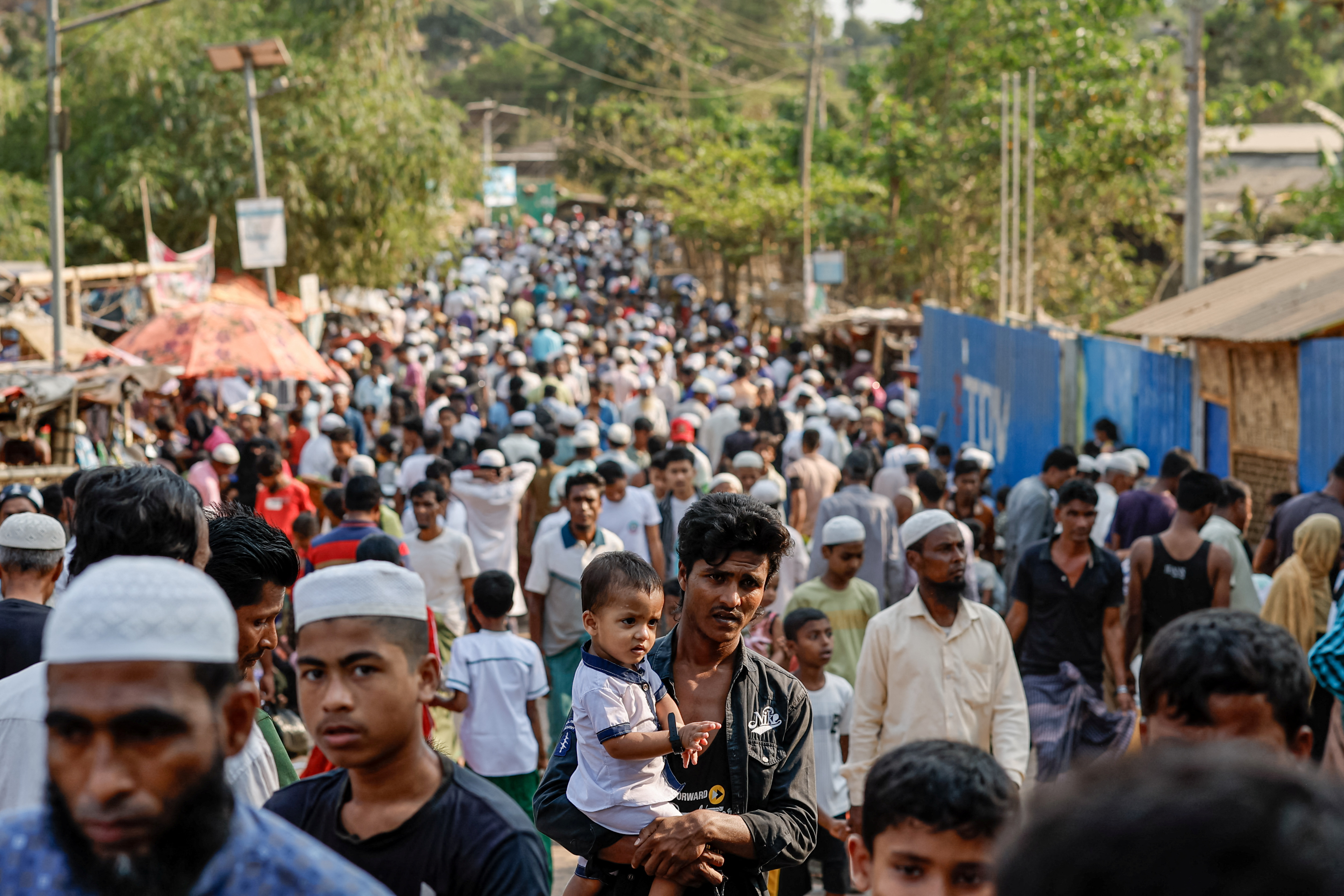 Rohingya refugees gather at roadside kitchen market, at the refugee camp in Cox's Bazar
