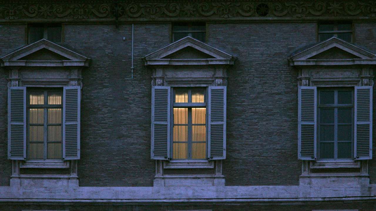 FILE PHOTO: Pope's apartment window above St. Peter's square remains lit at dusk in Vatican City.