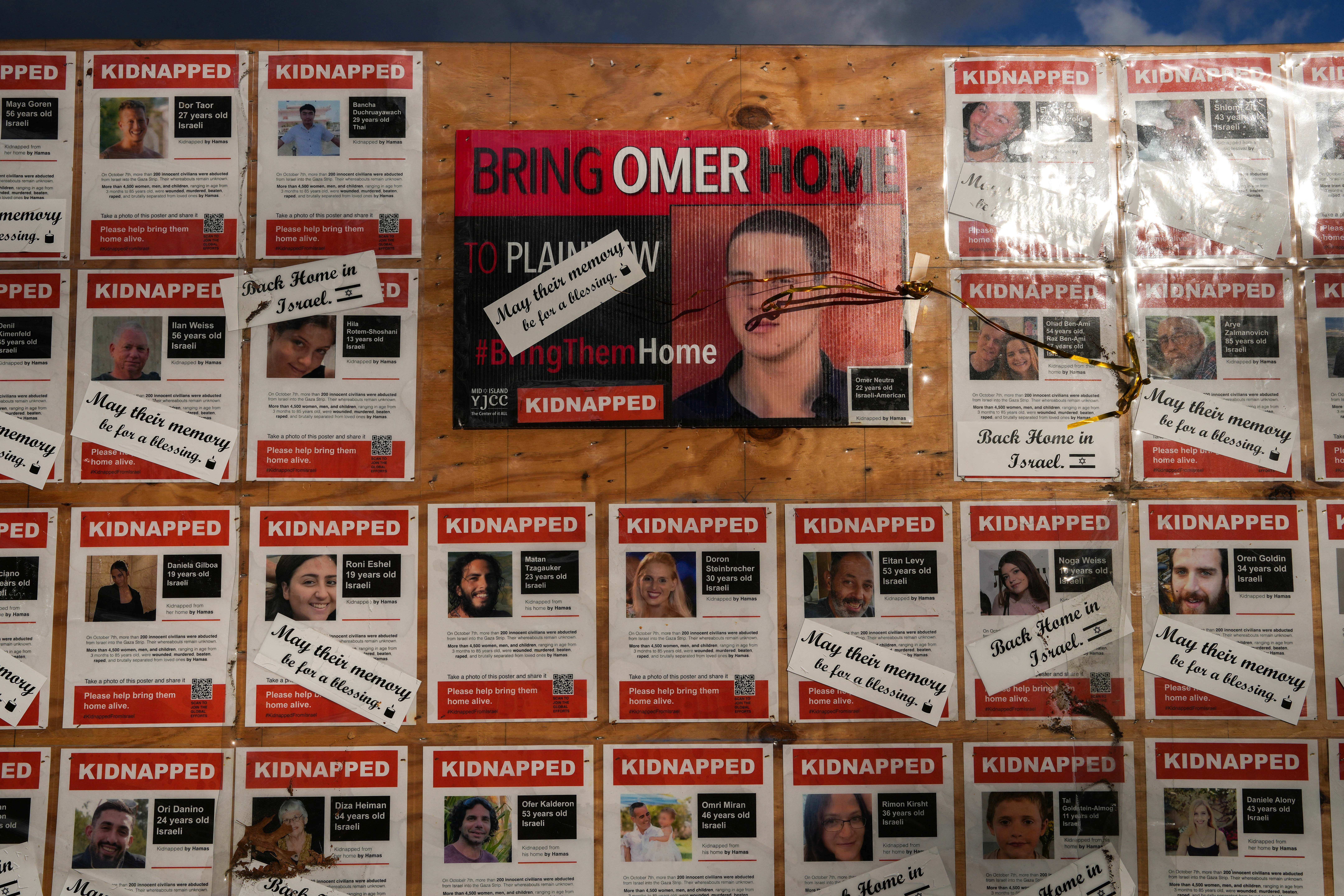 Posters of Israeli hostages are displayed in Plainview, New York, on the day of a memorial service for Omer Neutra, an American member of the Israeli Defense Forces