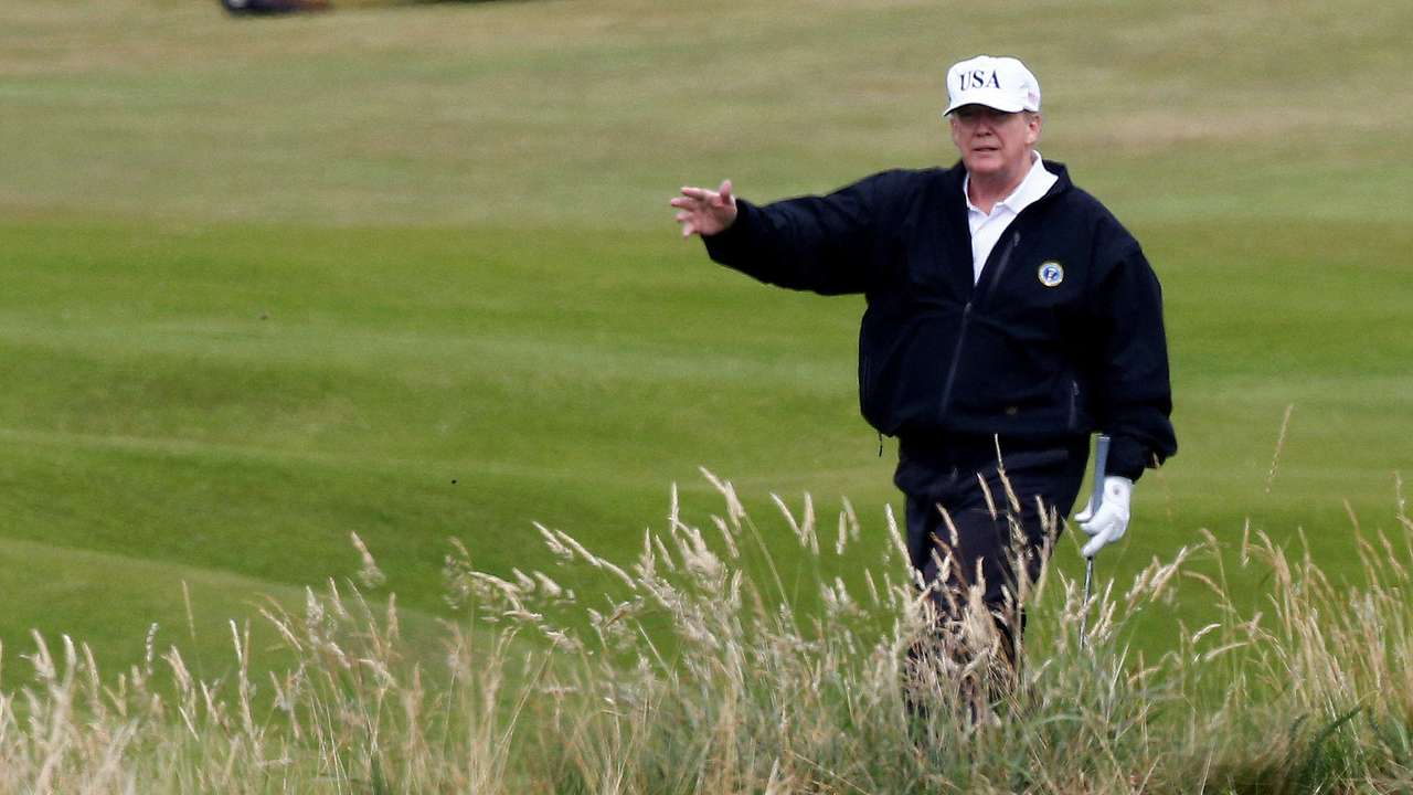 FILE PHOTO: Donald Trump gestures as he walks on the course of his golf resort, in Turnberry