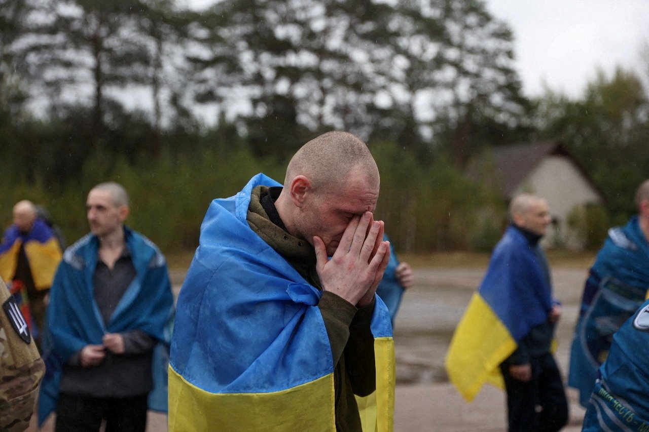 Ukrainian prisoners of war (POWs) gather after a swap at an unknown location in Ukraine