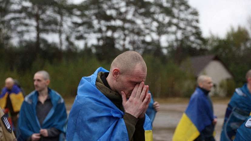 Ukrainian prisoners of war (POWs) gather after a swap at an unknown location in Ukraine