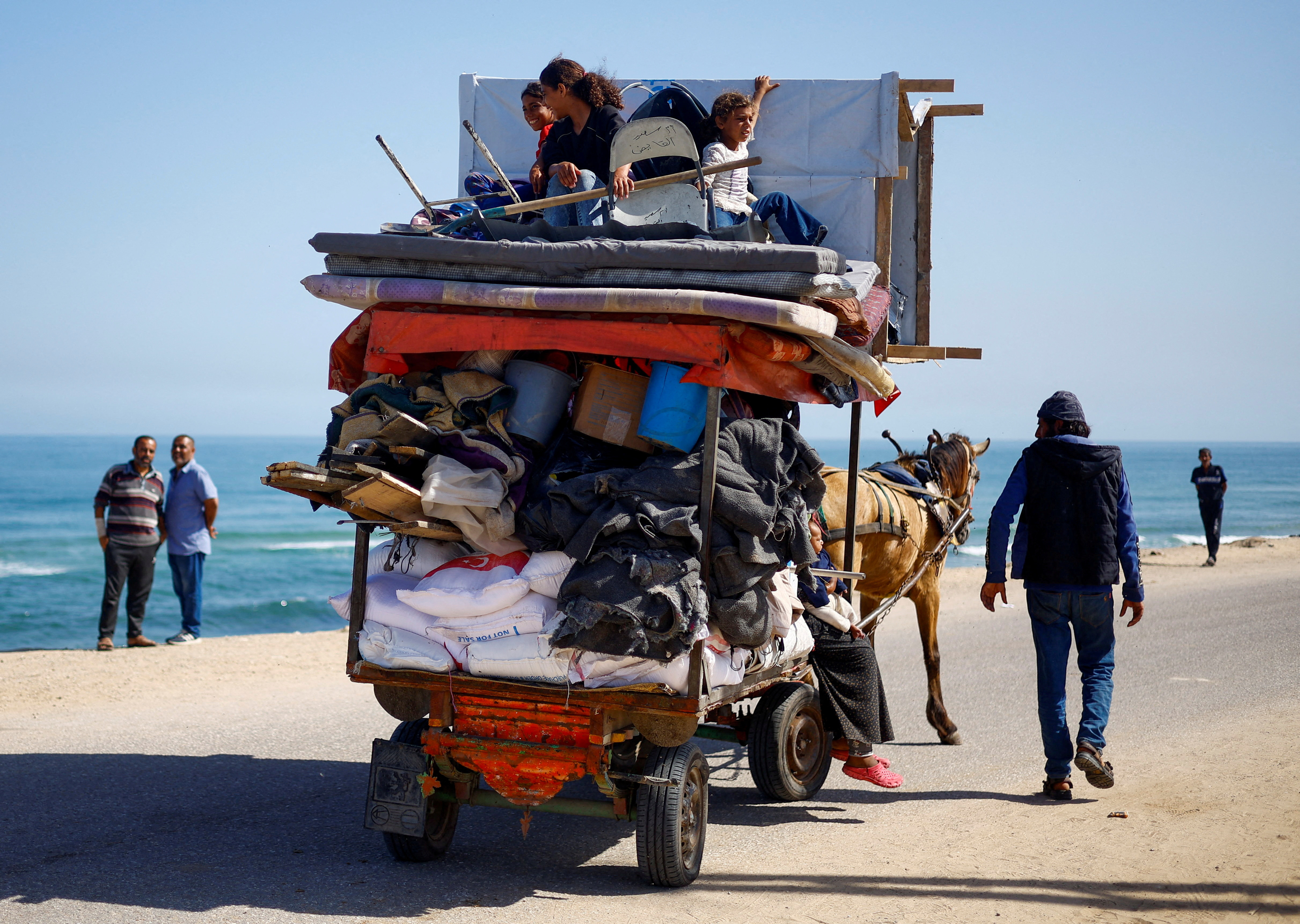 Palestinians evacuate after Israeli forces launched a ground and air operation in the eastern part of Rafah