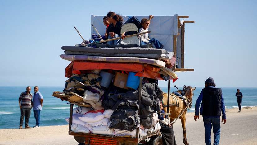 Palestinians evacuate after Israeli forces launched a ground and air operation in the eastern part of Rafah