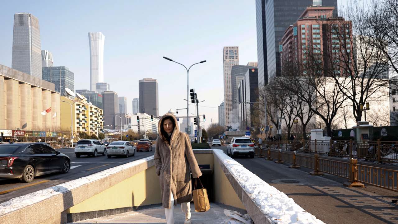 Woman walks on a street in Beijing's CBD on a cold winter day in Beijing