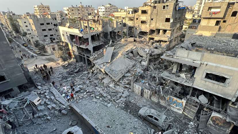 Palestinians search for casualties at the site of Israeli strikes on houses, in Gaza City