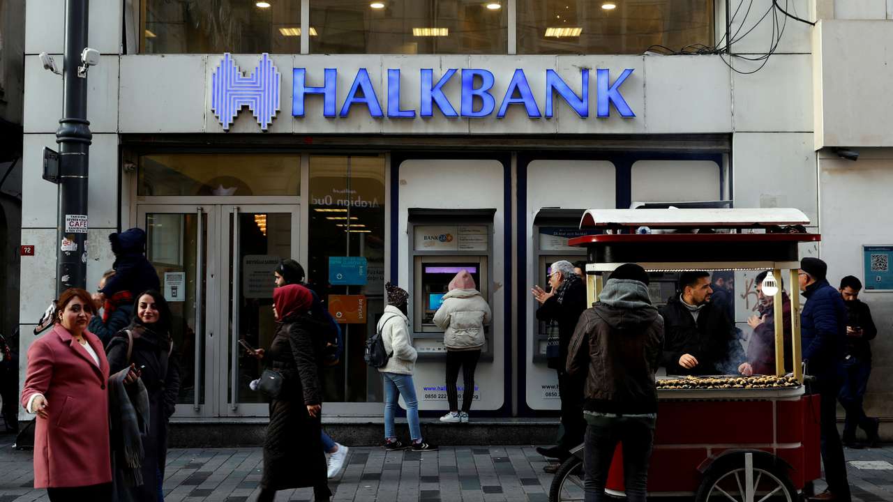FILE PHOTO: People walk past a branch of Halkbank in central Istanbul