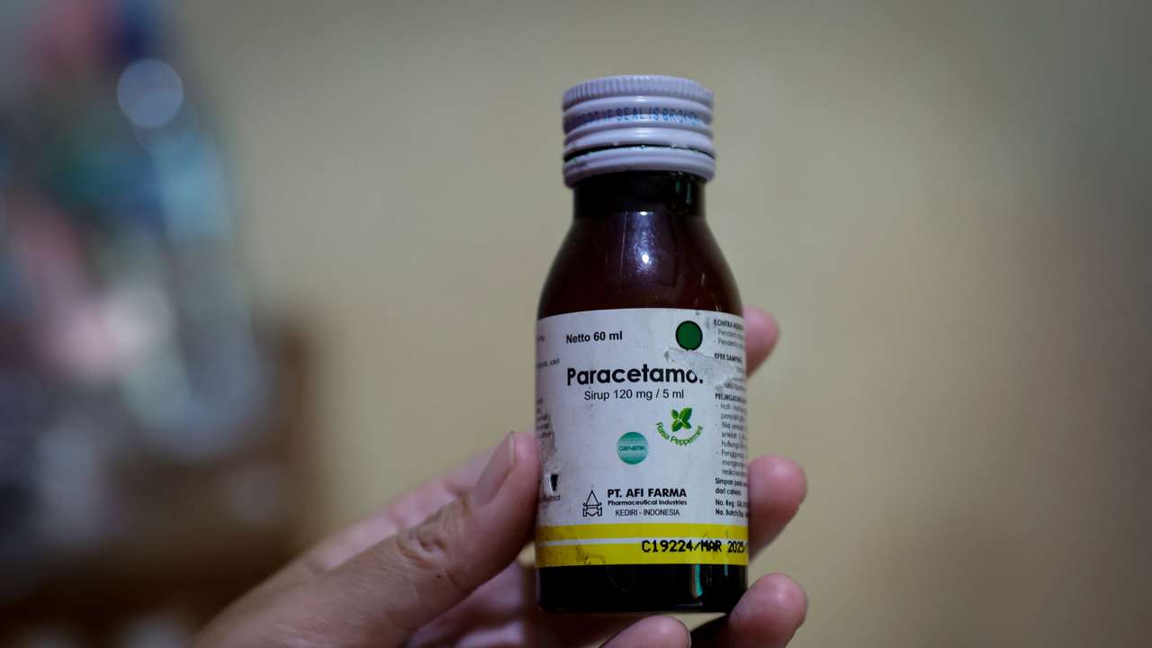 FILE PHOTO: Desi Permatasari shows a bottle of Afi Farma syrupat home in Bogor, Indonesia