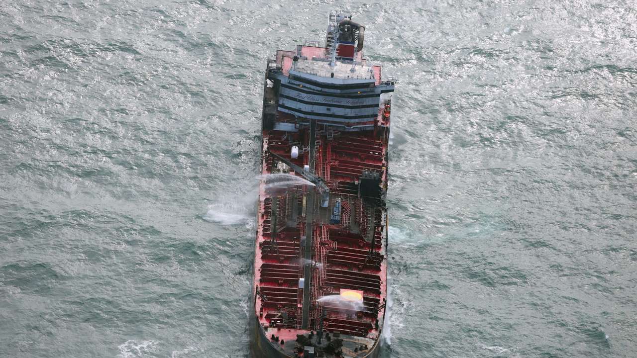 Aftermath of collision between container ship and oil tanker
