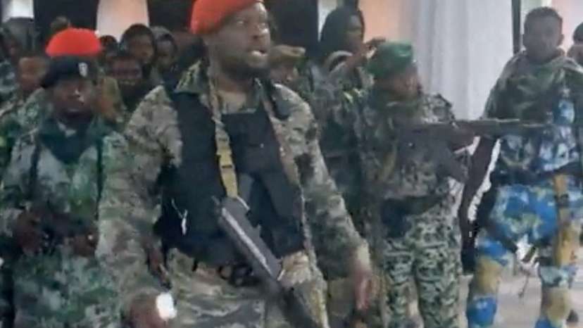 A man in military fatigues speaks inside the Palace of the Nation during an attempted coup in Kinshasa