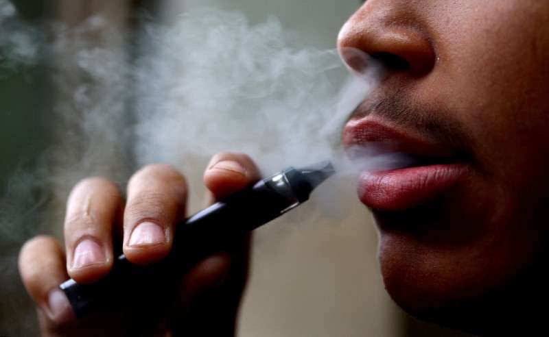FILE PHOTO: A man smokes a disposable vape