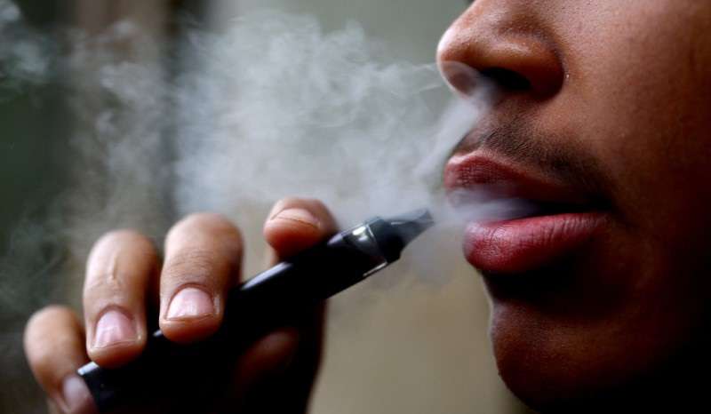 FILE PHOTO: A man smokes a disposable vape