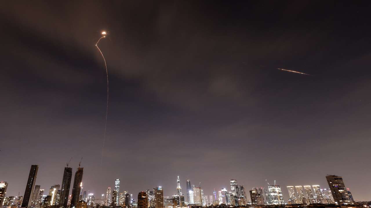 Streaks of light illuminate the sky during an interception attempt amid the U.S.-Israeli conflict with Iran, as seen from Tel Aviv