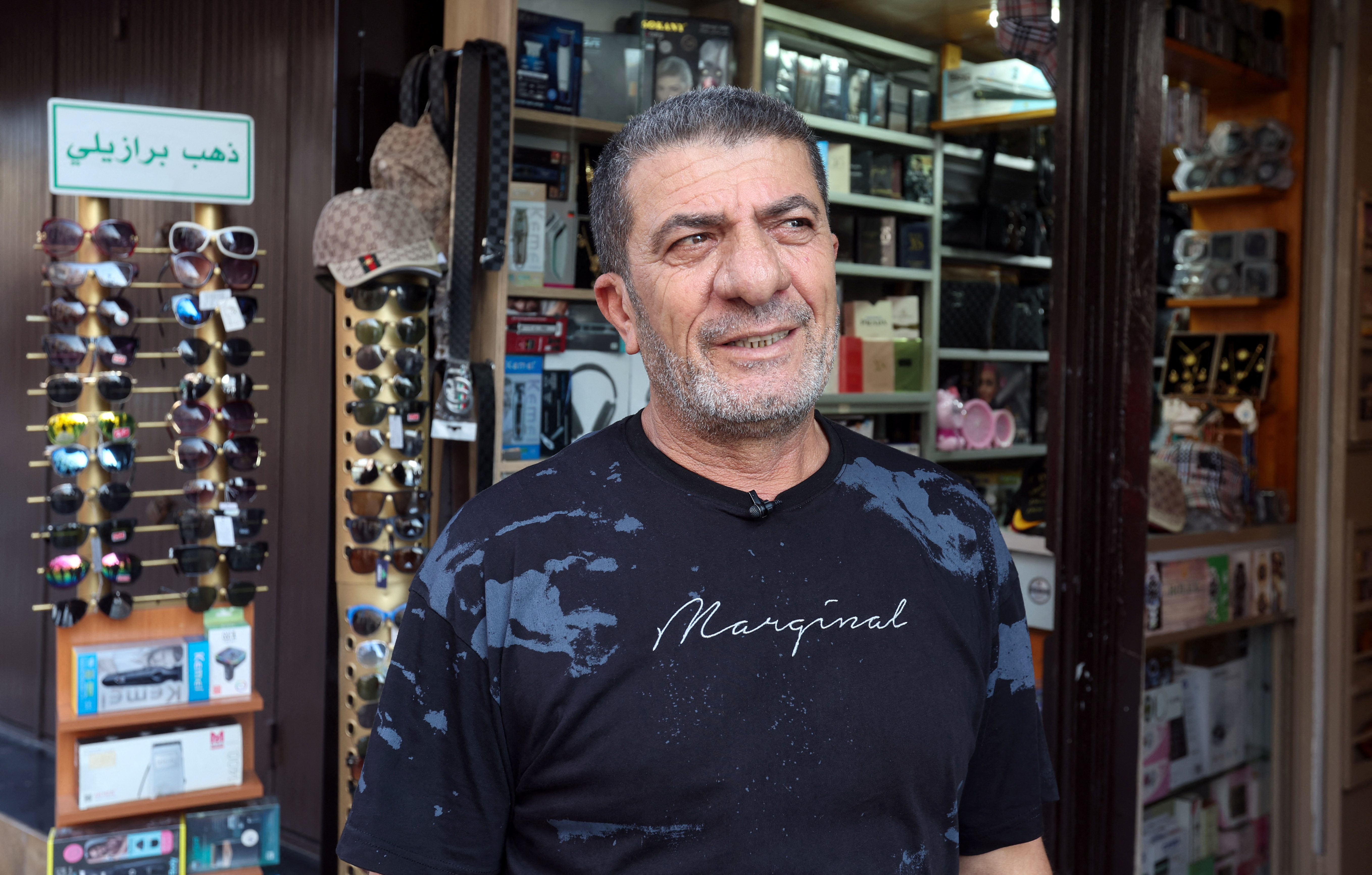 Shop owner attends interview with Reuters in Tyre