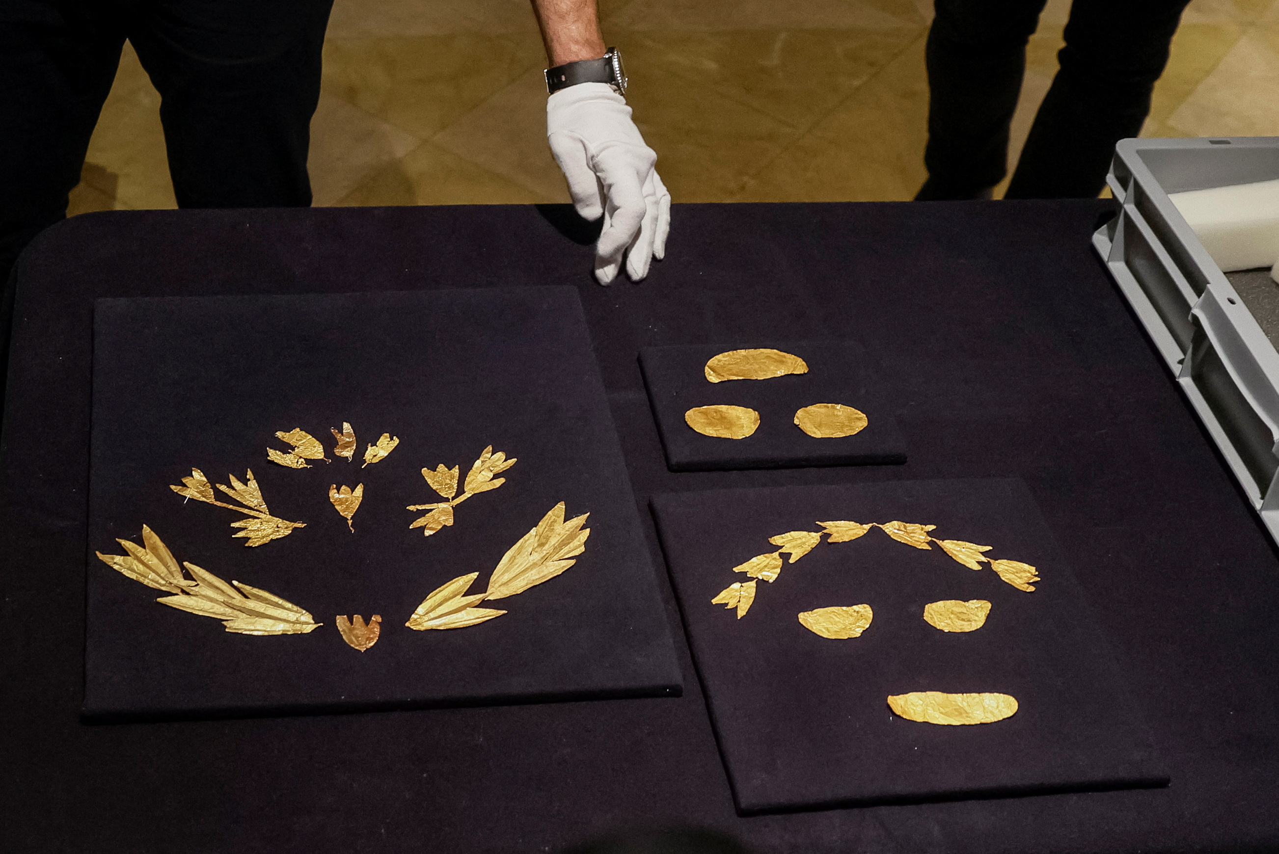 Museum expert unpacks a box with gold ancient Scythian artefacts from museums in Russia-occupied Crimea returned to Kyiv
