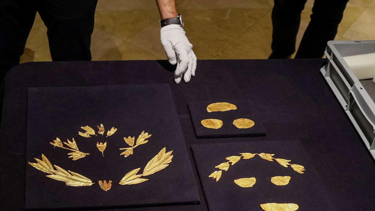 Museum expert unpacks a box with gold ancient Scythian artefacts from museums in Russia-occupied Crimea returned to Kyiv
