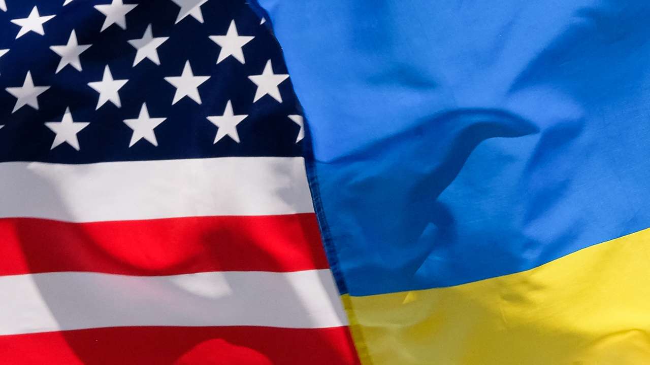 The American and Ukrainian flags wave next to each other.