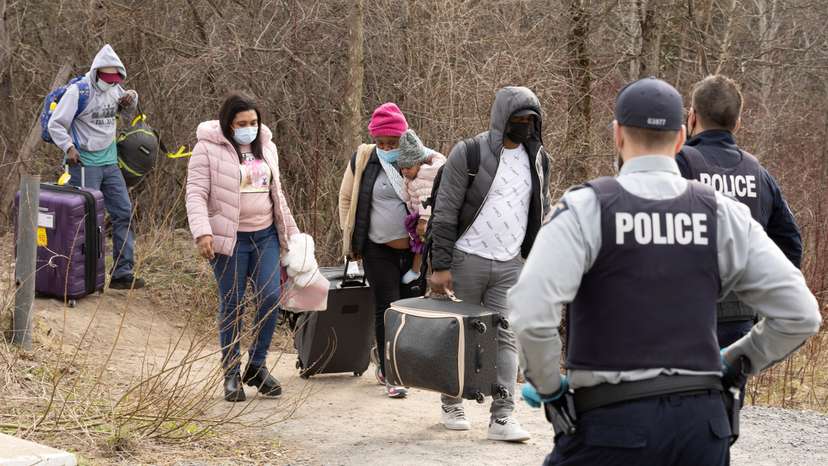 FILE PHOTO: Asylum seekers cross into Canada near a checkpoint on Roxham Road