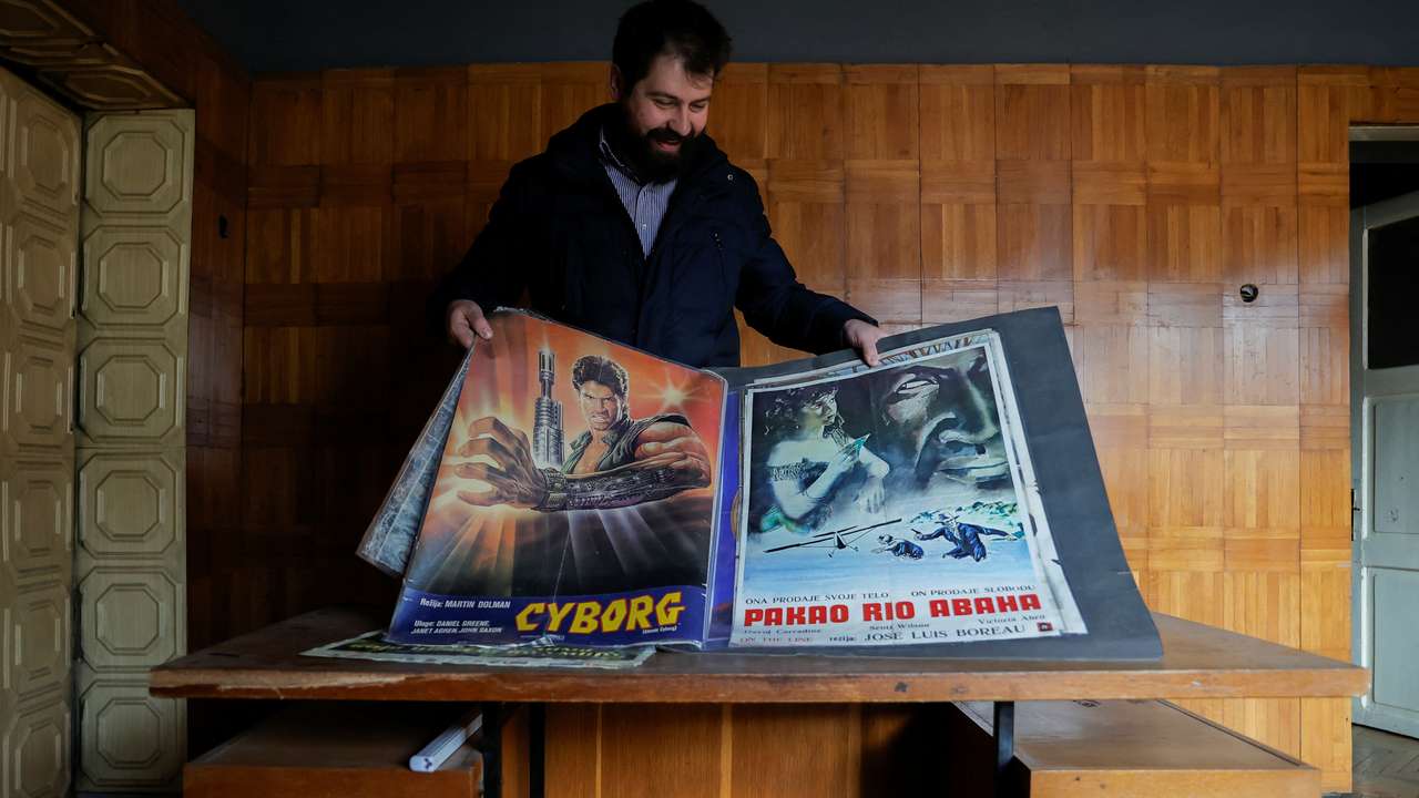 Ares Shporta shows old movie posters at the Lumbardhi cinema, in Prizren