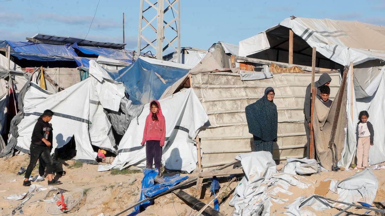 Palestinians inspect the damage at the scene where an Israeli strike killed Hamas political leader Salah al-Bardaweel and his wife in their tent shelter, in Khan Younis