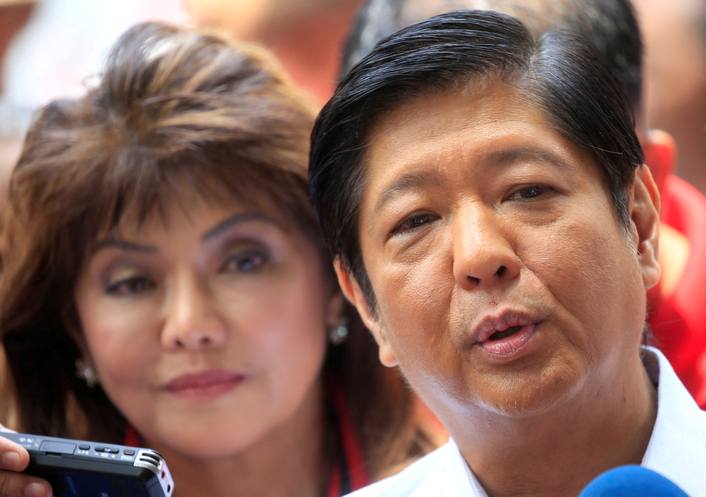FILE PHOTO: Ferdinand "Bongbong" Marcos and his sister Imee, children of late dictator Ferdinand Marcos, answer questions during a press briefing at the Supreme Court in Padre Faura