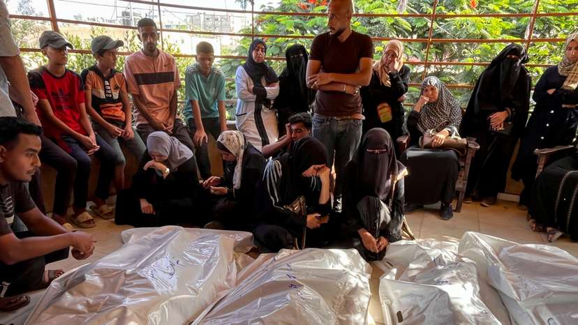 Mourners grieve next to the bodies of Palestinians killed in Israeli strikes, amid the Israel-Hamas conflict, at Nasser hospital in Khan Younis in the southern Gaza Strip