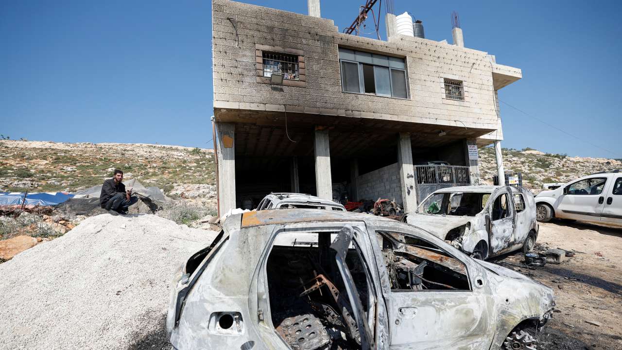 Palestinians inspect damage after Israeli settlers attacked the village of al-Mughayyer